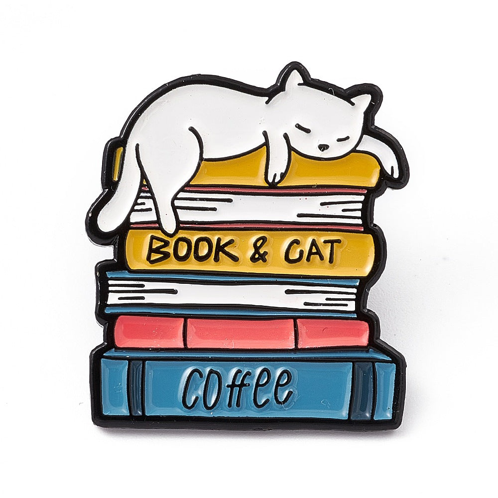 Cat laying on pile of books enamel pin