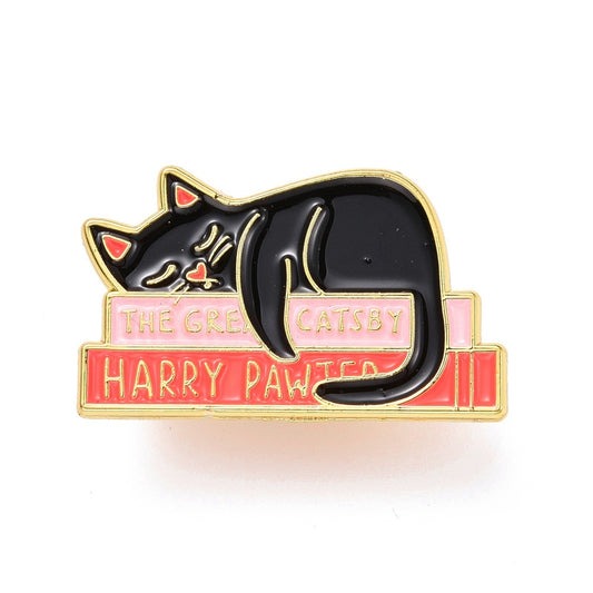 Cat sleeping on books enamel pin